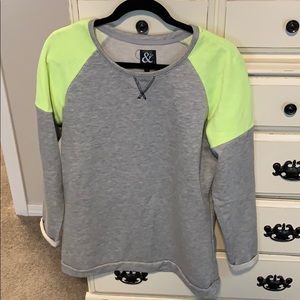 Grey sweater with neon green around shoulder